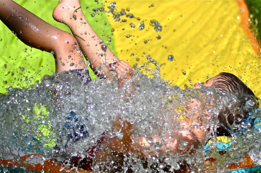 He is sliding into the little pool for a very large splash!