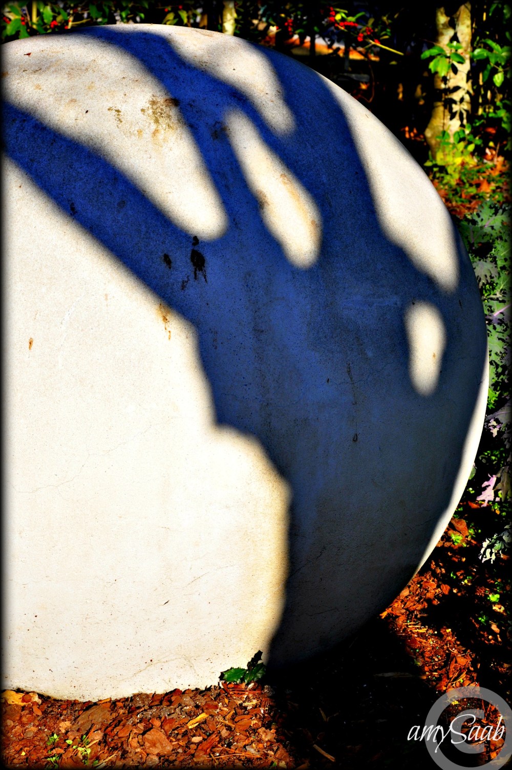 fingers grabbing a cement ball