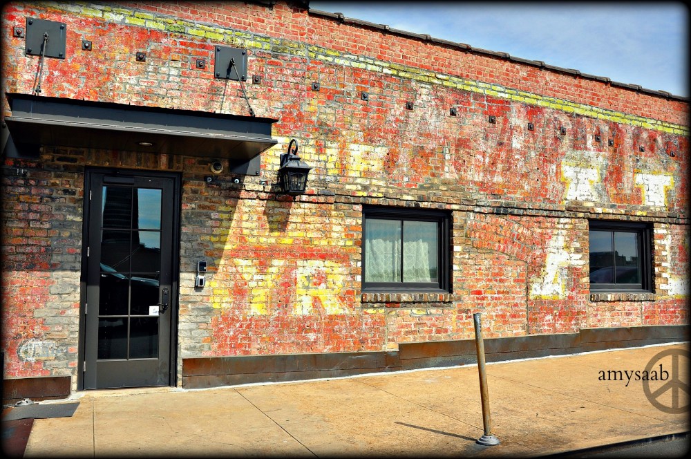 I LOVE the owner of this building put in new doors & windows, but left all the painted history remaining.